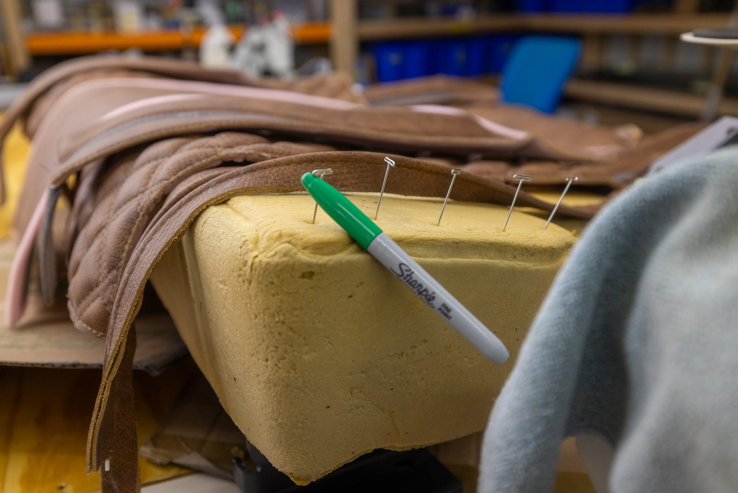 Hand-cut foam pad with leather pieces pinned and marked for stitching at the Frankman Motor Company custom interiors shop in Harrisburg, SD