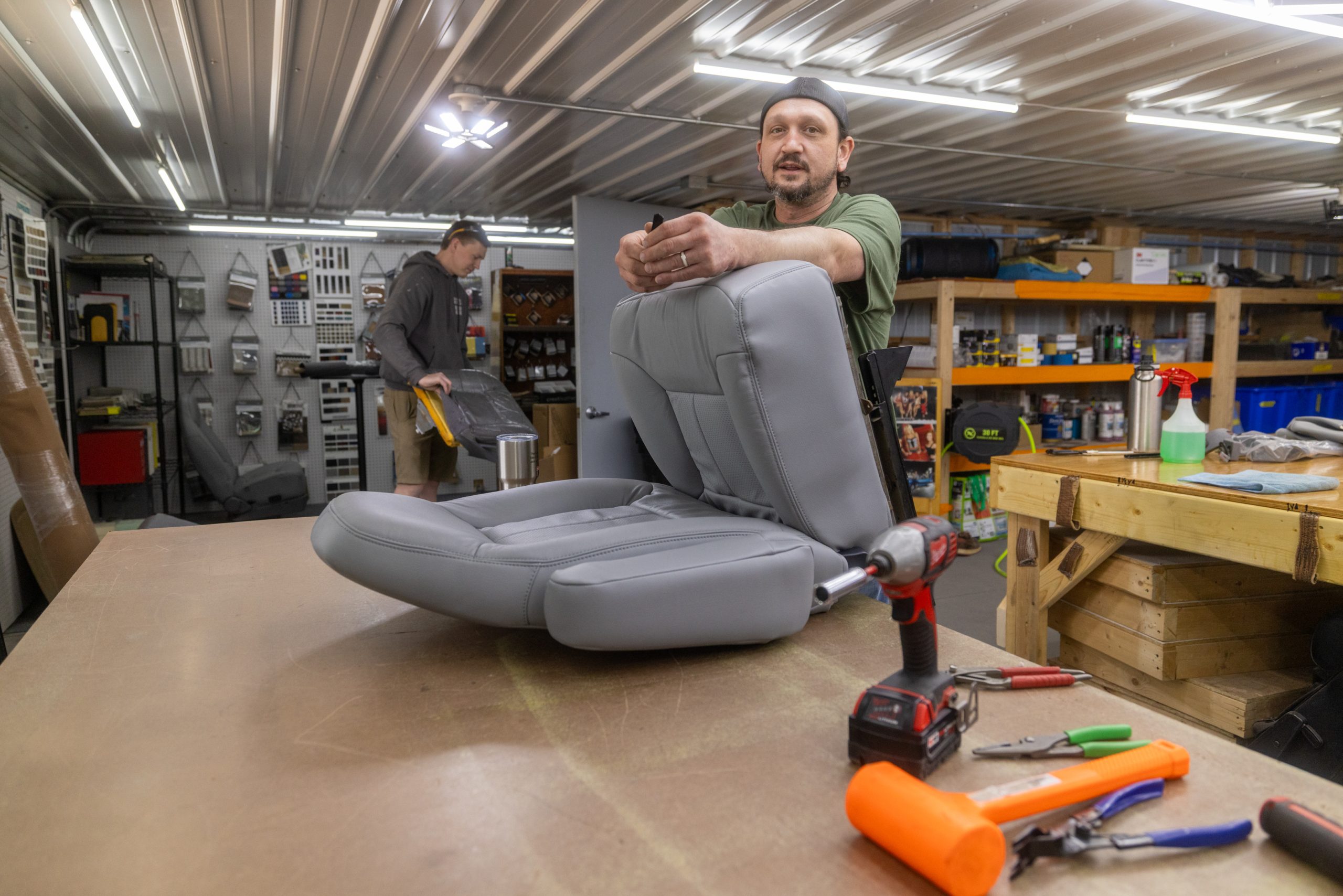 John fitting a custom gray leather seat on the bench at the Frankman Motor Company interior shop